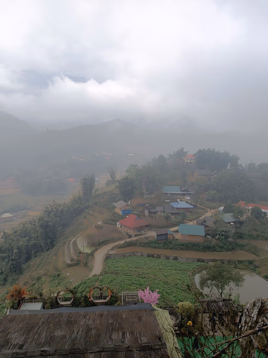 Cat Cat village houses, terraces and a pond under low winter cloud, Sapa