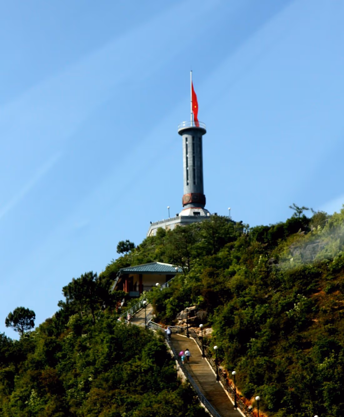 Lung Cu flag tower on its wooded hill with the stone stairway climbing to it