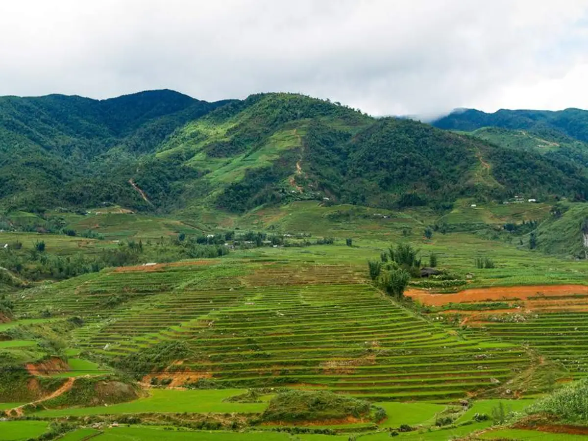 Rice terraces and mountain ridges in the Sapa valley — the destination waiting after arriving through Hanoi