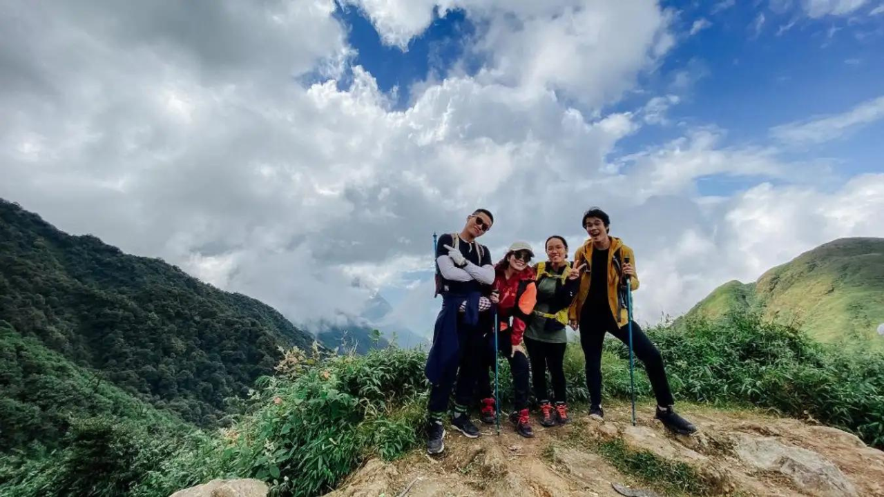 Trekking group on the Fansipan 2-day route with panoramic mountain views above the clouds