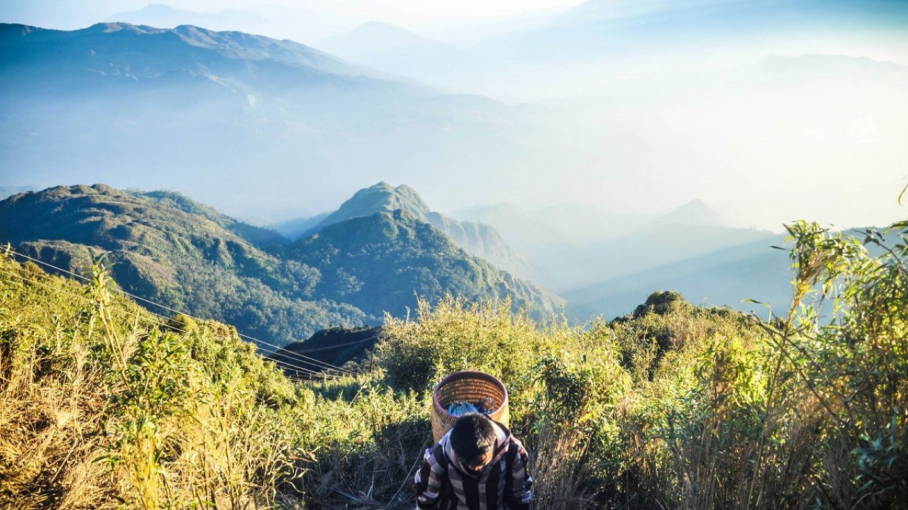 Vietnam flag at the Fansipan summit marker 3,143m — Mount Fansipan 2 Days Trek, Sapa