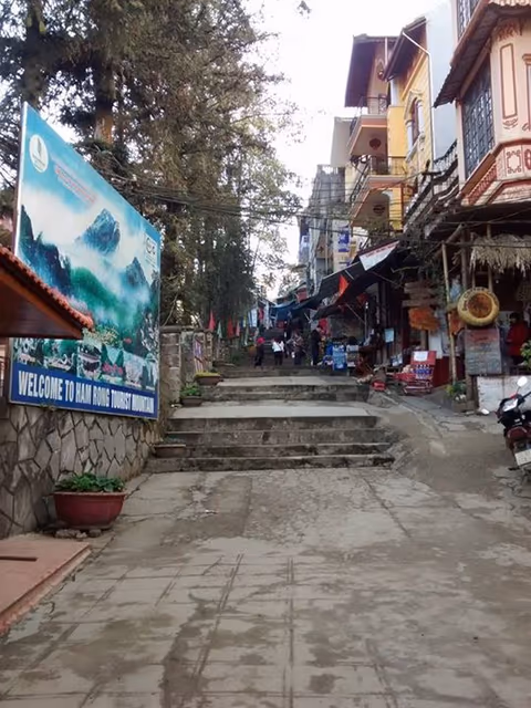 Stone entrance steps and Welcome to Ham Rong Tourist Mountain sign at the base of Ham Rong Mountain, Sapa town