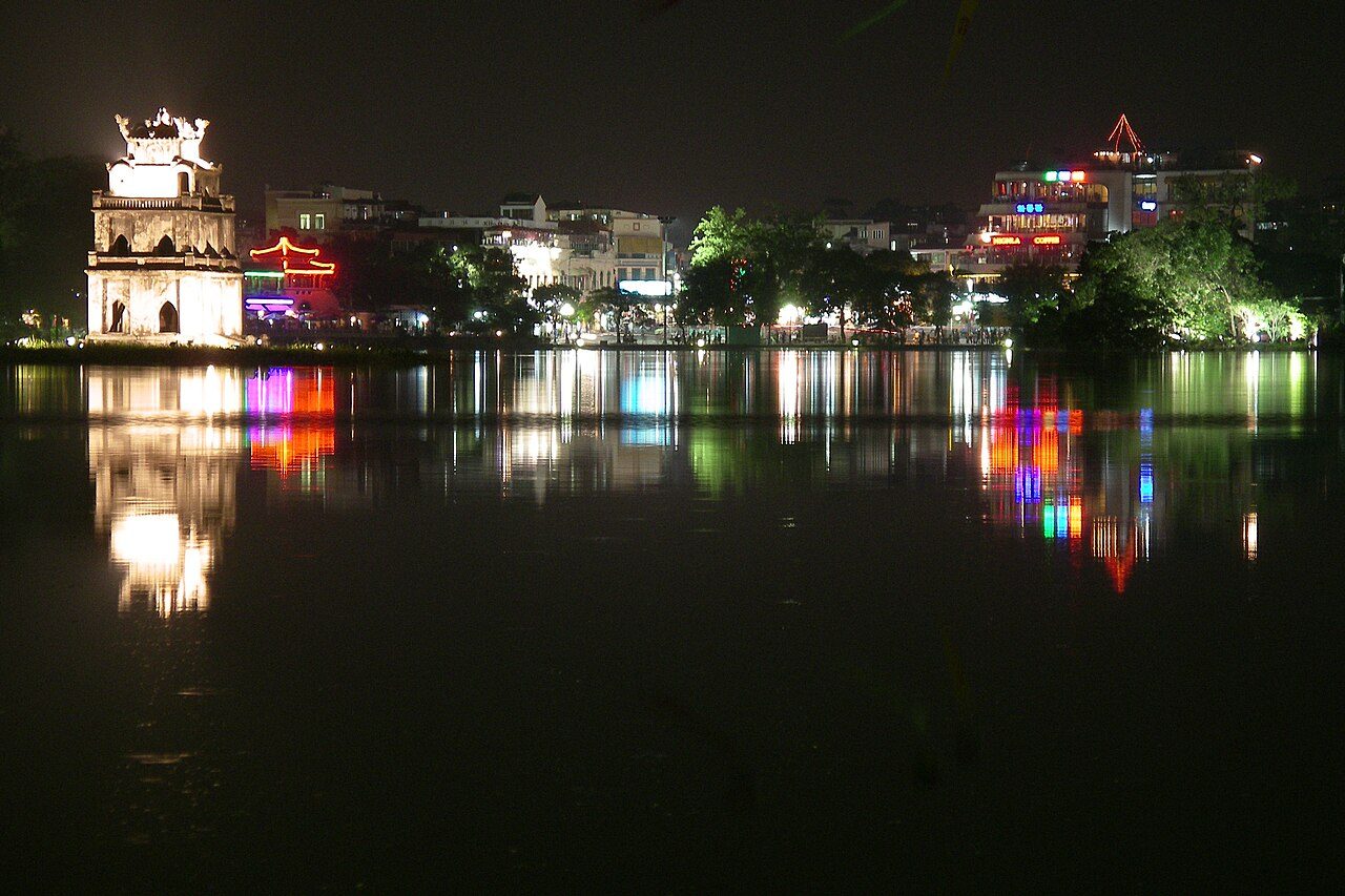 Hoan Kiem Lake in Hanoi at night with the illuminated Turtle Tower reflected in the water