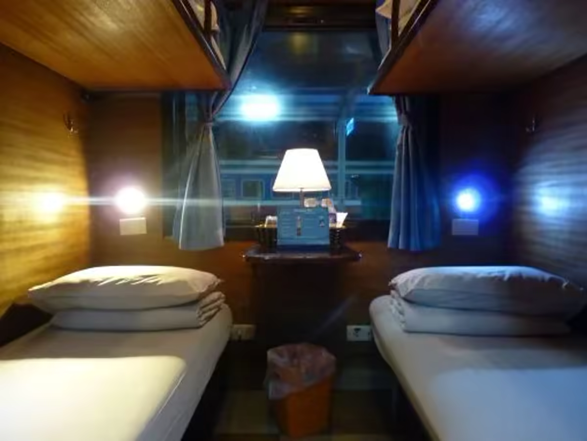 King Sapa Train 4-Berth Deluxe cabin with two lower berths, reading lamp and window table, Hanoi to Lao Cai sleeper