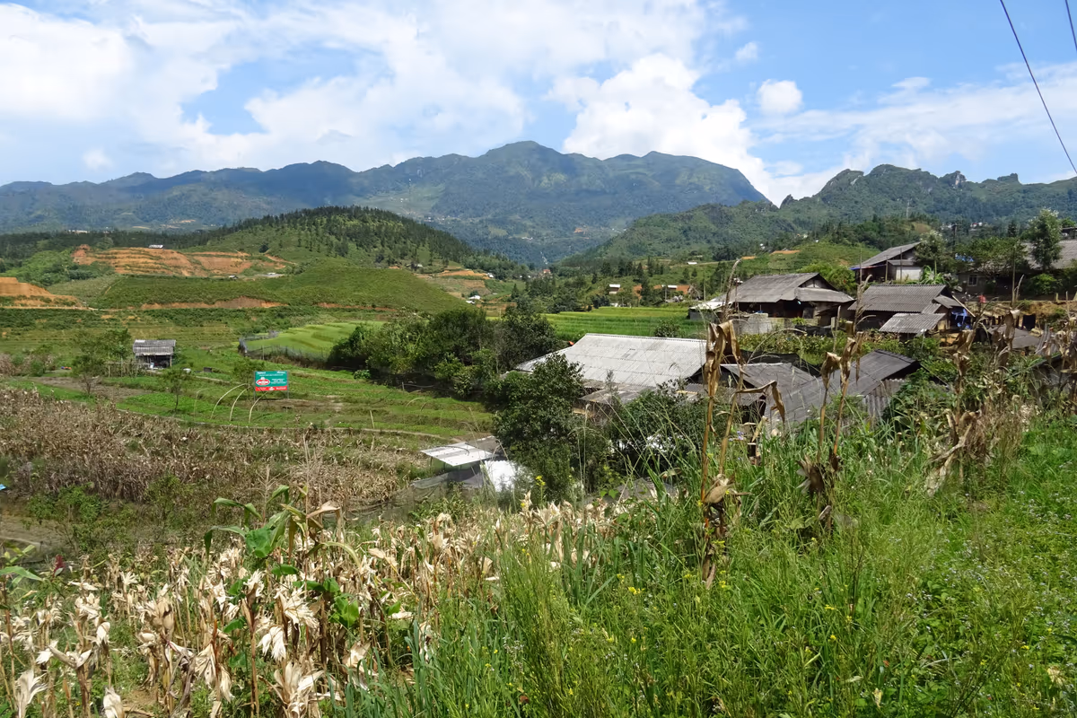 Village roofs and rice terraces across the valley on the trail between Ta Phin and Sapa, in the Ma Tra valley