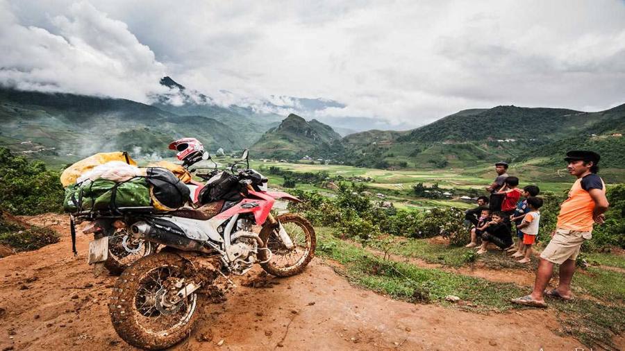 Motorbike rider on the winding mountain road above Sapa