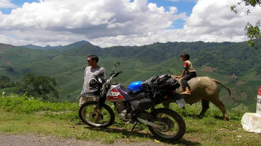 Traditional H'mong wooden homestay in Hau Thao village — overnight stop on the motorbike tour