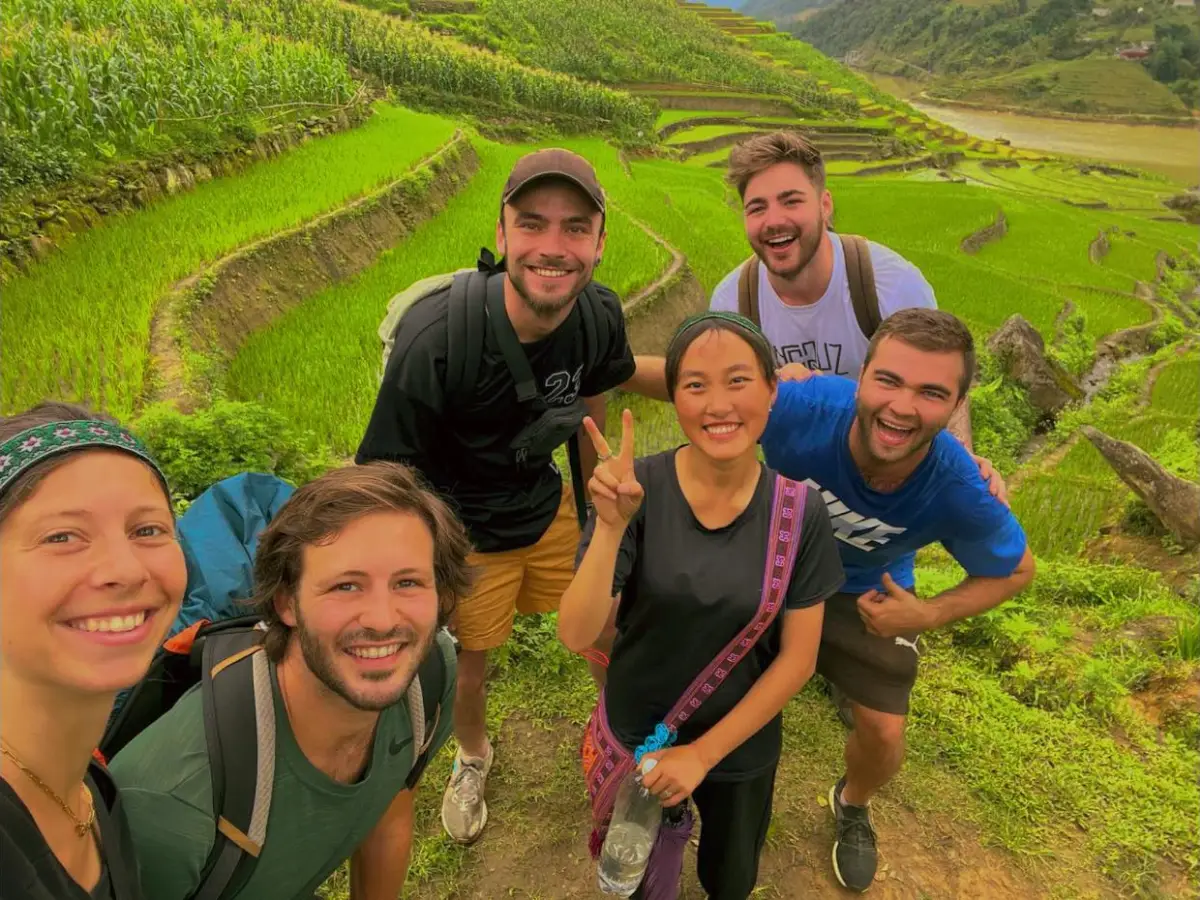 Happy group selfie with H'mong guide on rice terrace Sapa