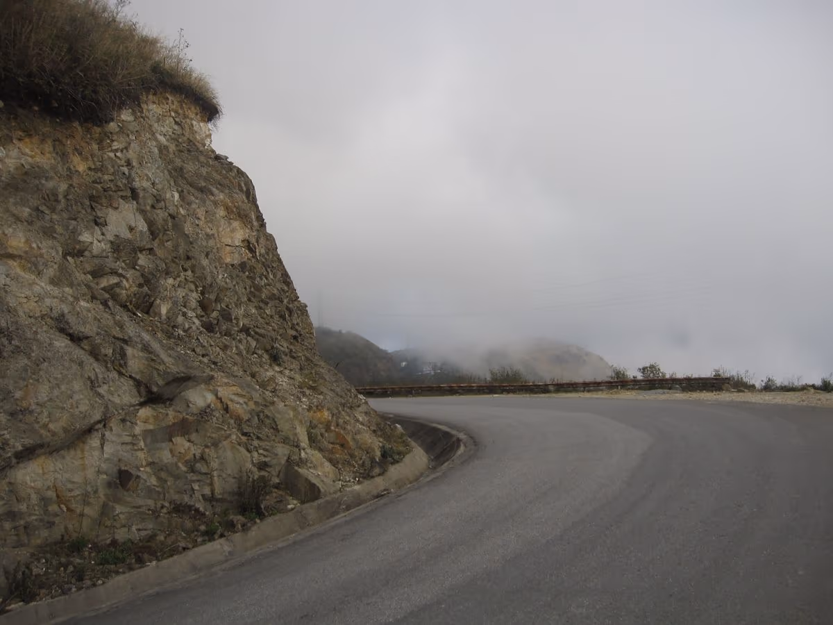 A bend of the O Quy Ho Pass road in mist near the top of the pass