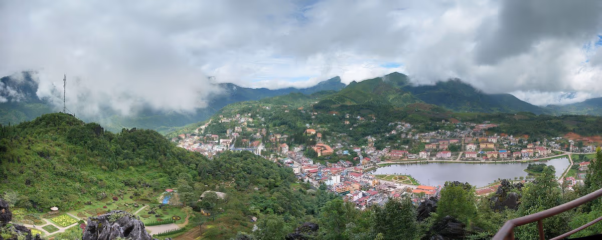 Panorama of Sapa town and its lake from Ham Rong Mountain with low cloud hanging on the surrounding ridges