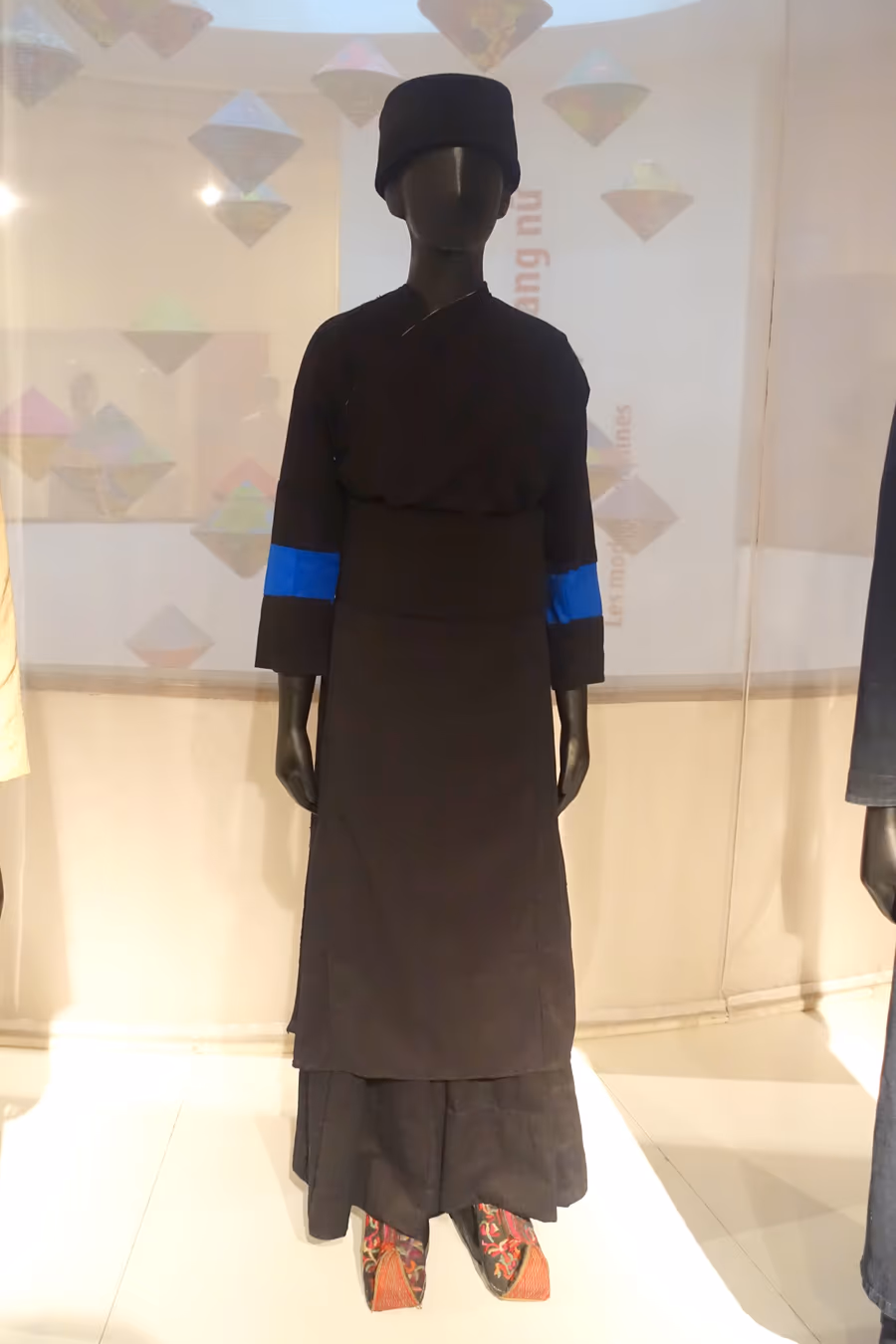 A Tay woman's indigo cotton costume from Lao Cai province, displayed on a mannequin at the Vietnamese Women's Museum, Hanoi
