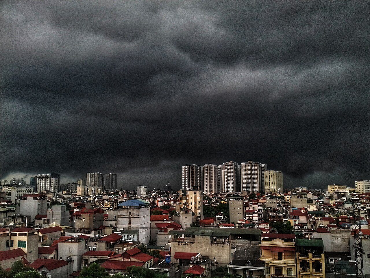 Dark monsoon storm clouds over Hanoi before rain, illustrating Vietnam's rainy season