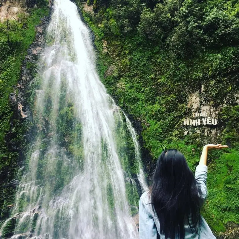 Traveler at Love Waterfall (Thác Tình Yêu) in Hoang Lien National Park on the Sapa waterfalls day tour